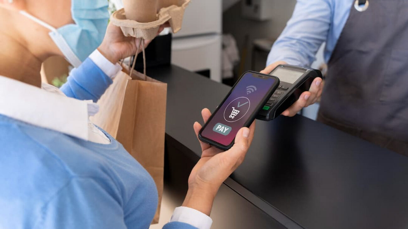 female-customer-paying-takeaway-food-with-smartphone-2-1300×731